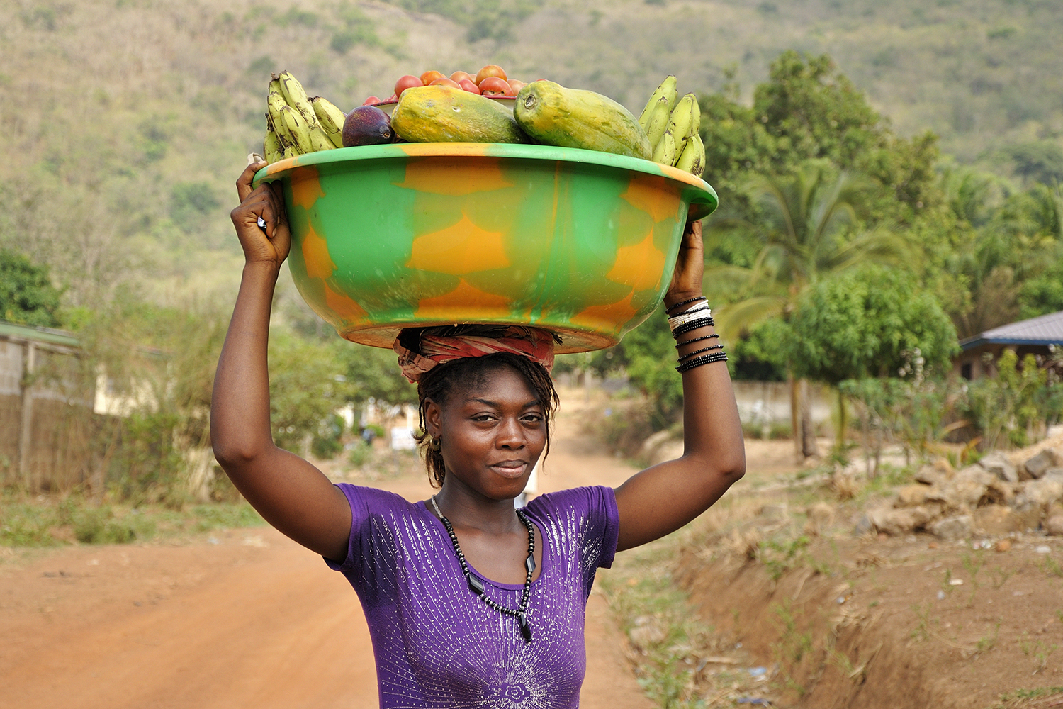 Woman carrying produce to market in Kabala, Sierra Leone