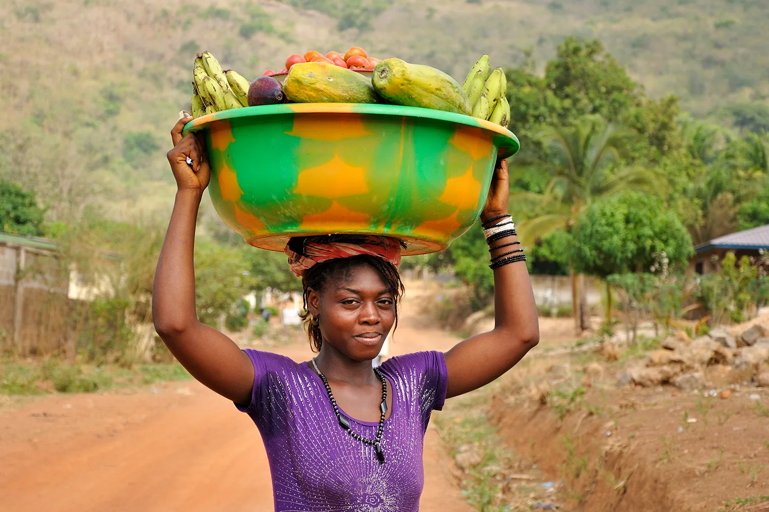 Woman carrying produce to market in Kabala, Sierra Leone