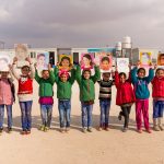 Girls with portraits at Za'atari Refugee Camp