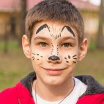 Boy with painted face at art program